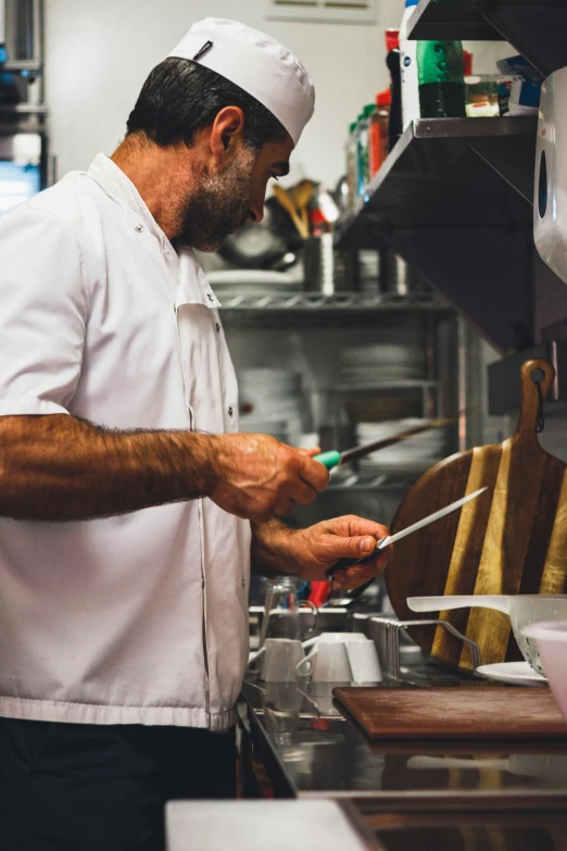 the man in the kitchen is cooking and preparing food