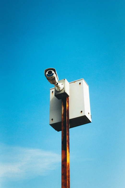 a clock and a building on a pole