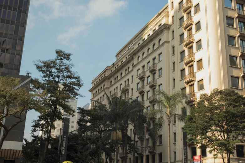 tall building in a large city street near tall buildings