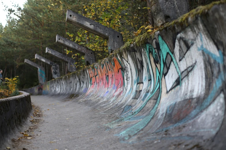 skateboarder jumping high in air with colorful wall