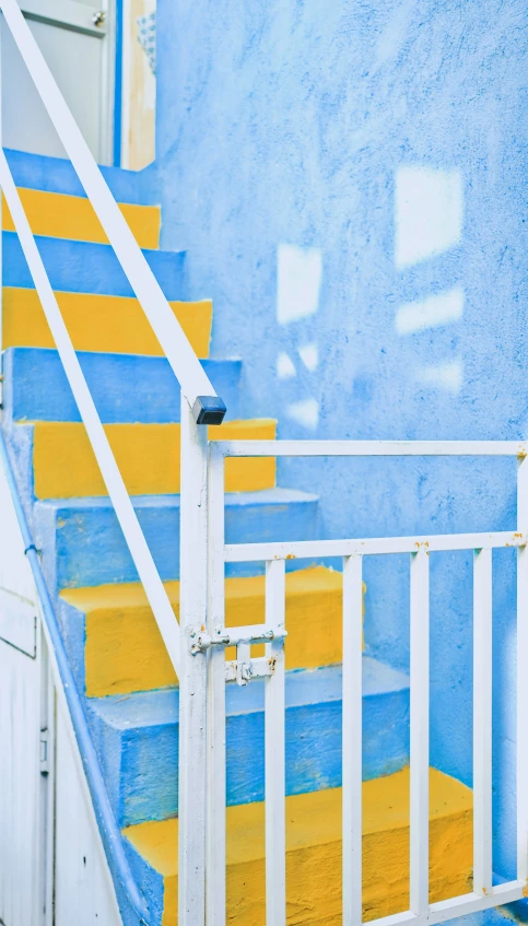 a white railing with yellow steps up the side