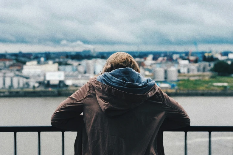 a woman looks out over a city skyline