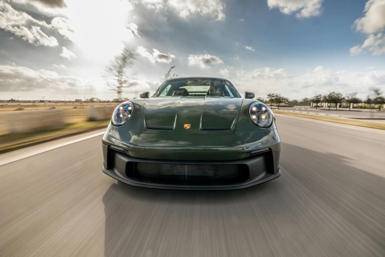 a black sports car speeding down the road