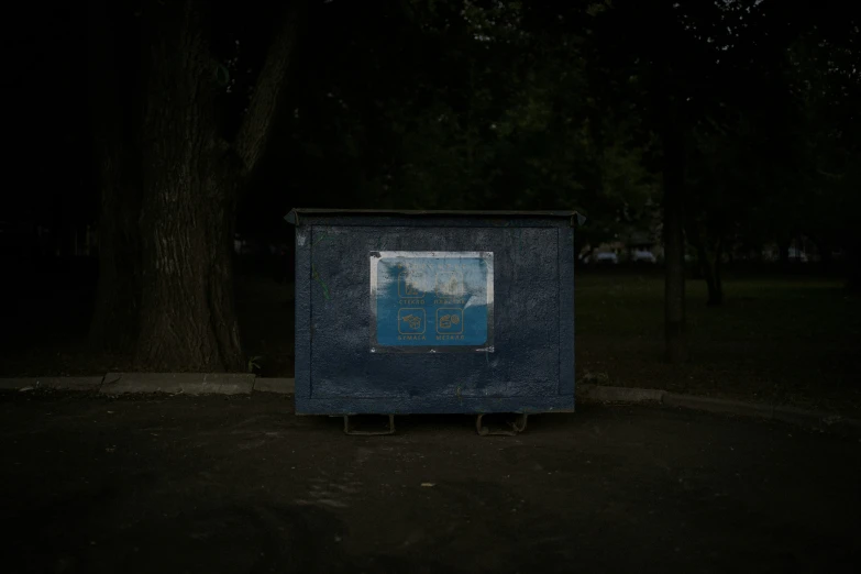 a park type outhouse sits at night