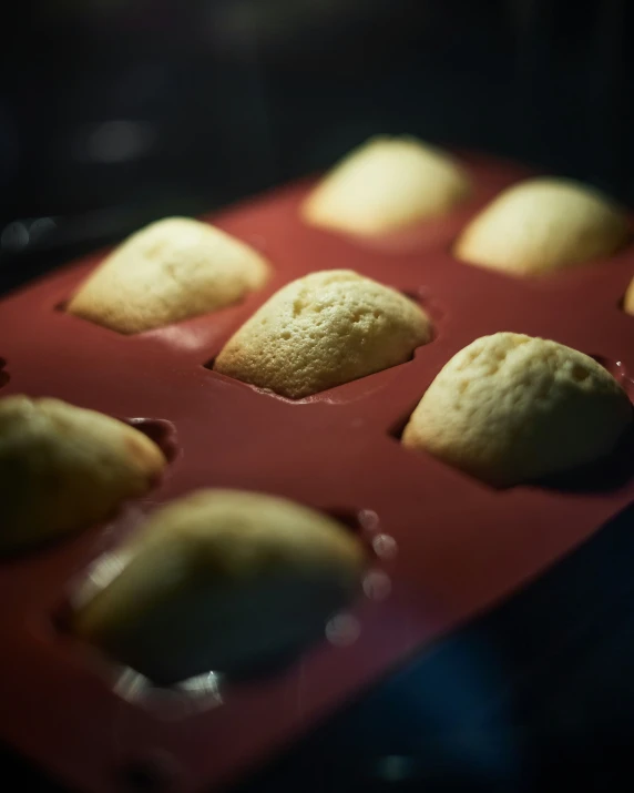 a pan filled with small pastries on top of a counter