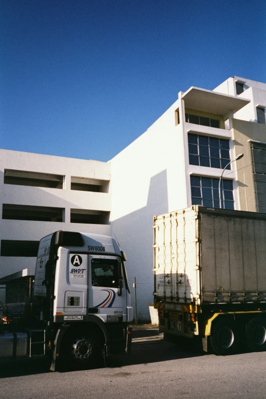 there is a semi truck parked next to a building