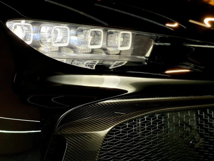 the back lights of a parked car with a grill in the front