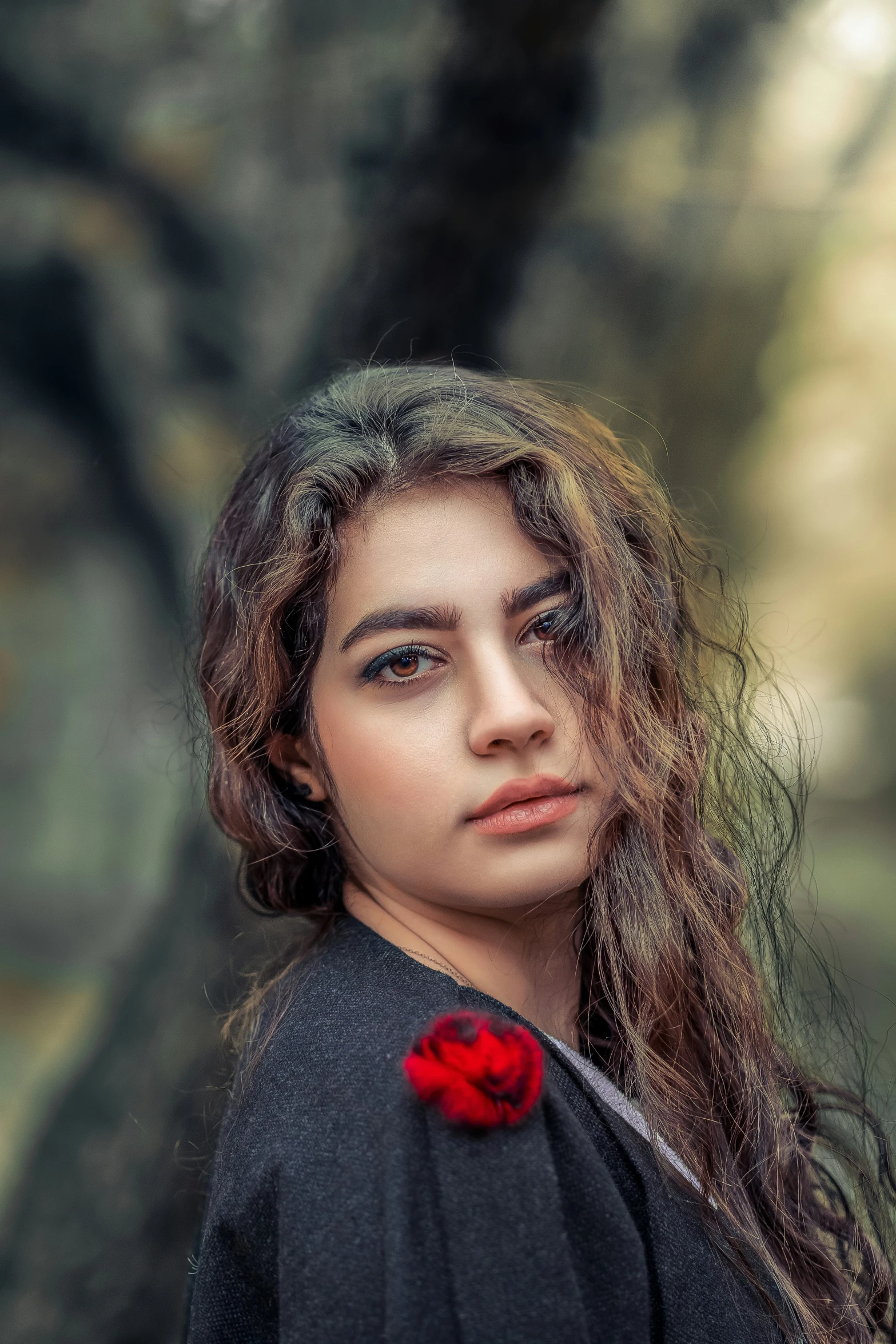 the girl in the forest is holding a rose