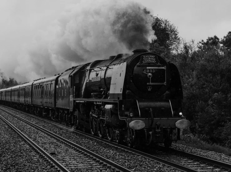 a train with its black cars is on the tracks