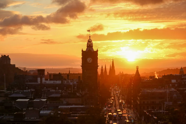 a sunset scene in the city that has traffic on it