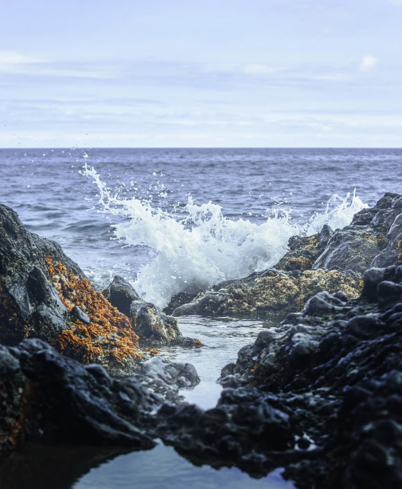 a large body of water next to some rocks