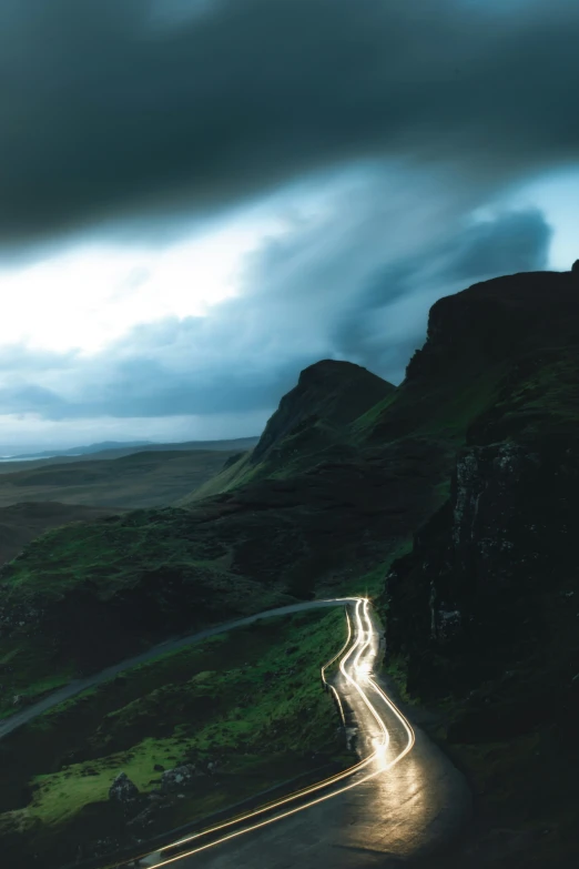 a car travels through the countryside at dusk