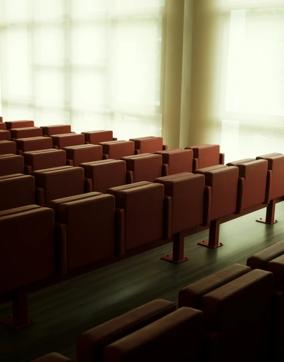 rows of brown seats and chairs in a room