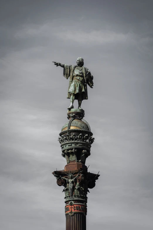 a statue standing on top of a tall building