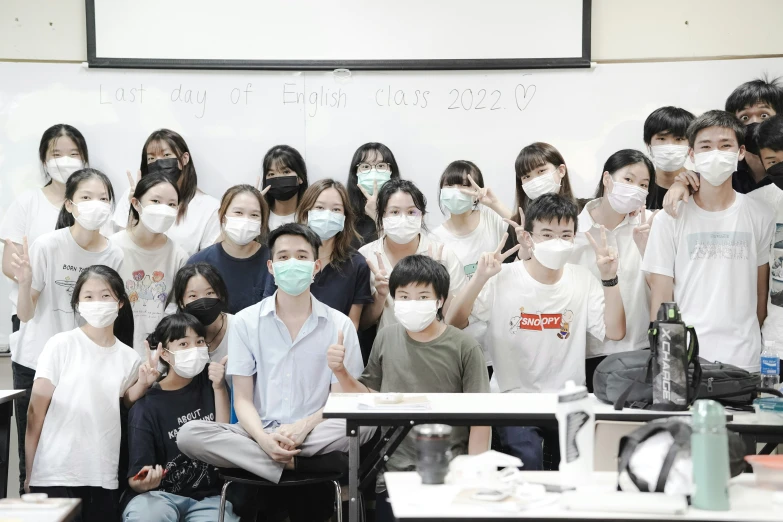 group of students standing and posing for po wearing face masks
