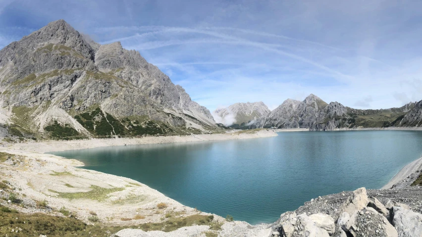 a lake is surrounded by mountains in the wilderness