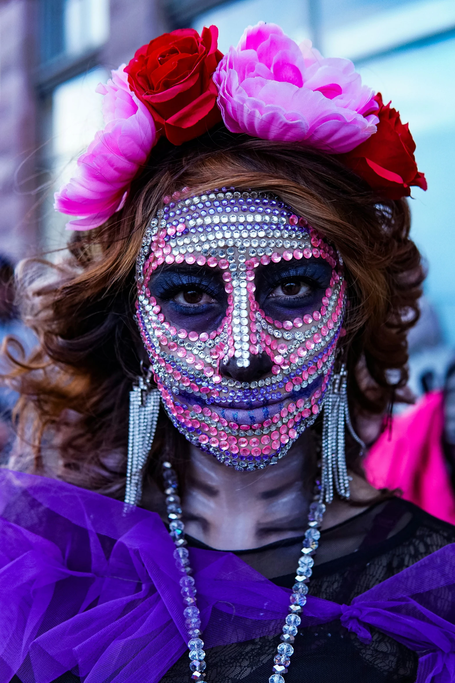 a close up of a woman with makeup and decorations on her face