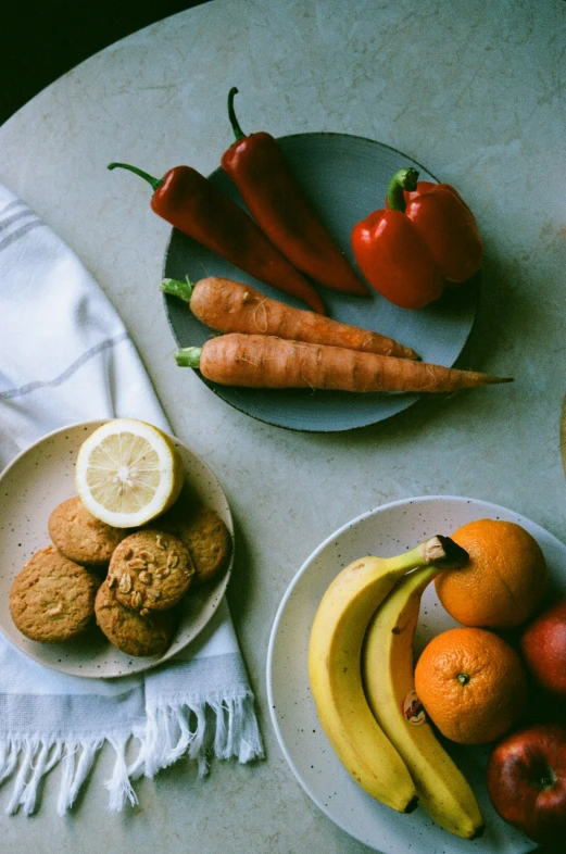 some fruit and vegetables on plates on a table