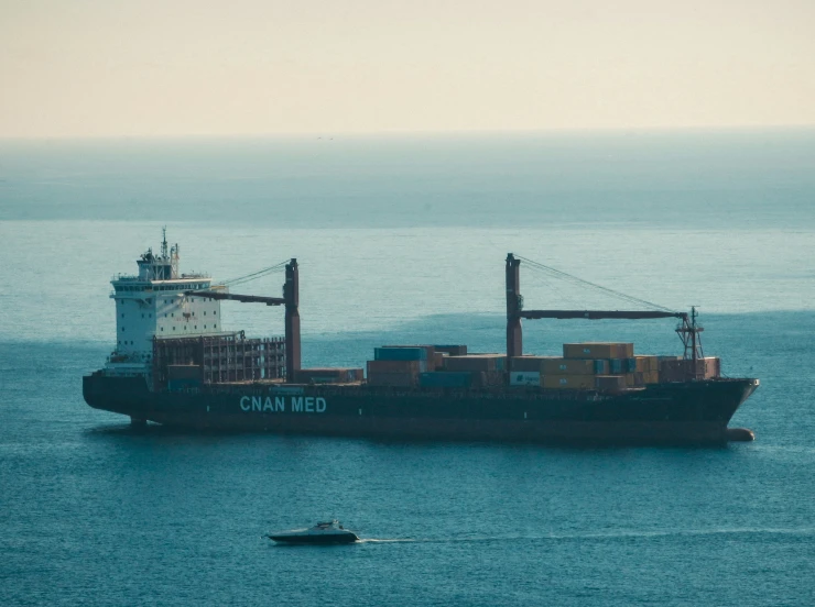 a large boat floating in the ocean on a cloudy day