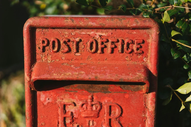 an image of an old style post with two elephants