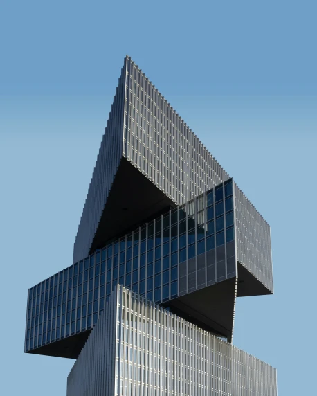 two intersecting, silver and glass buildings with a blue sky background