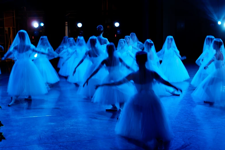 an image of dancers in white on stage