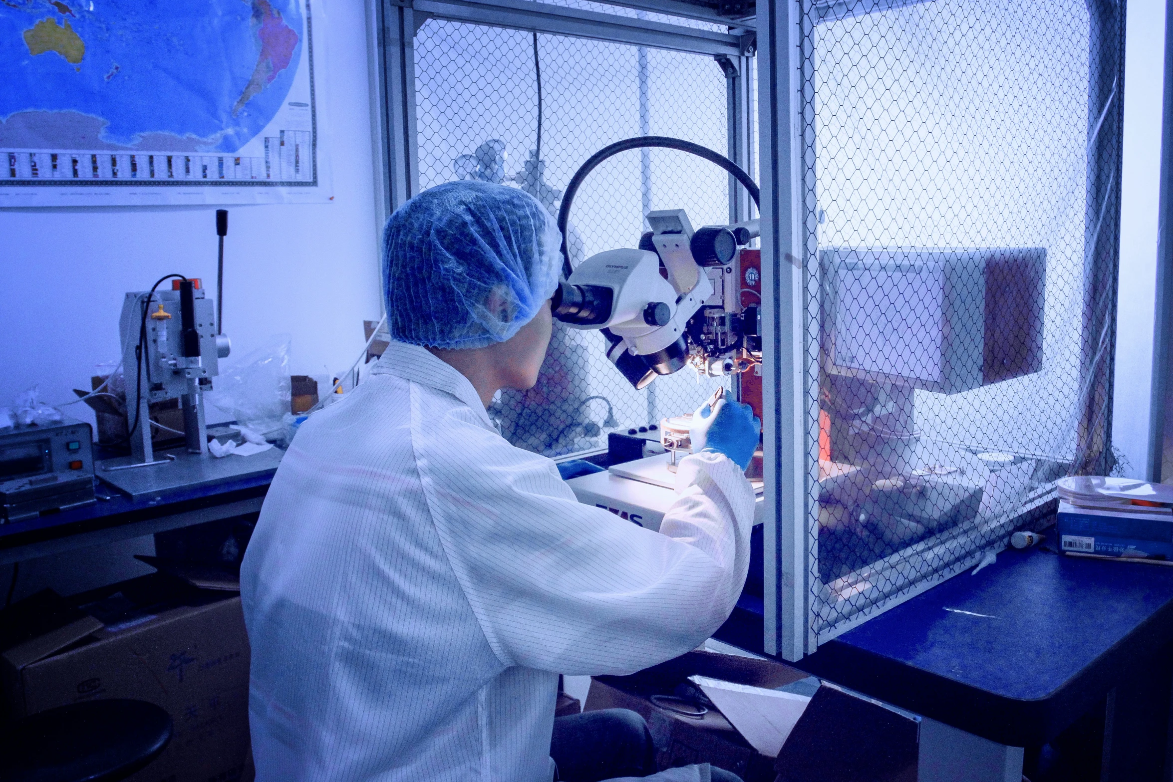 the person in white shirt is working in the laboratory