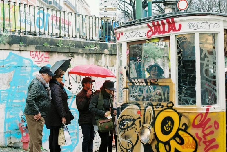 several people standing next to a small trolley