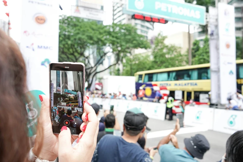 a woman taking pictures with her phone of the street