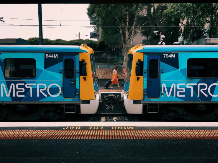 two trains are parked on the train tracks