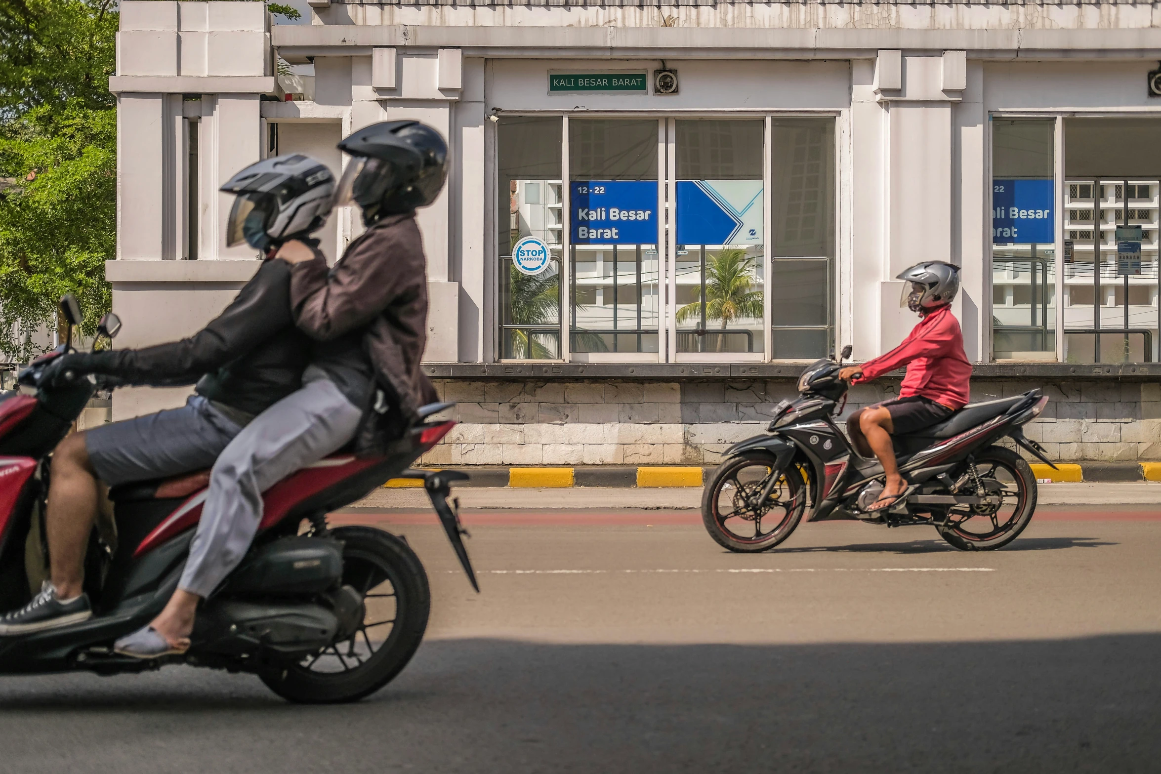 there are two people riding motorcycles on the road