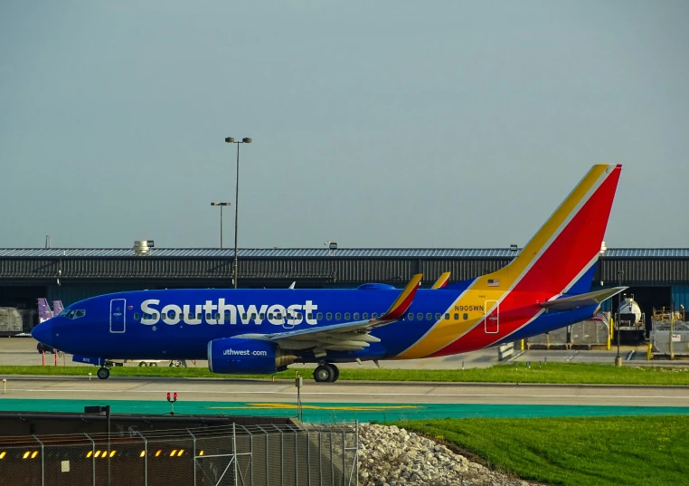 a southwest jet plane parked on the runway