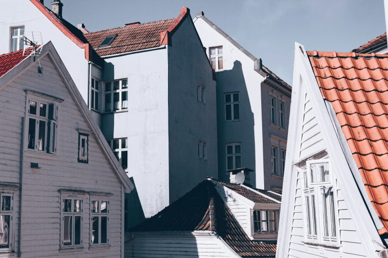 old wooden buildings line the sidewalk of an european town