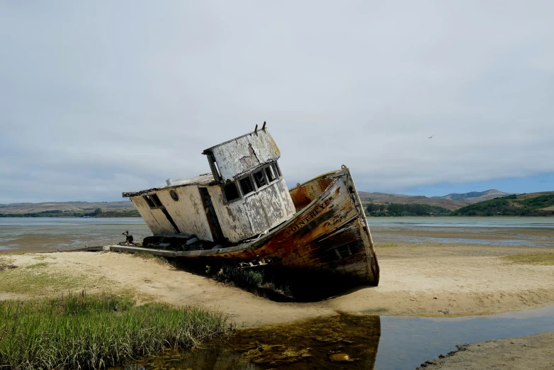 a boat with four hulls is sitting on the shore