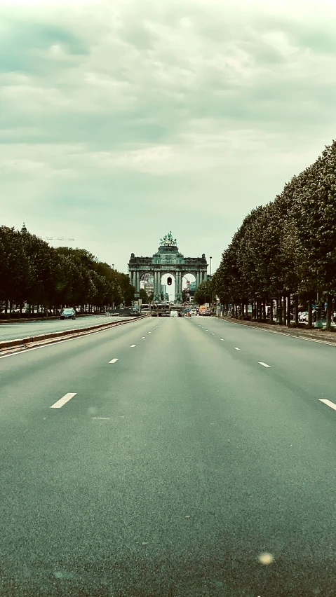 a deserted street that stretches into a large building