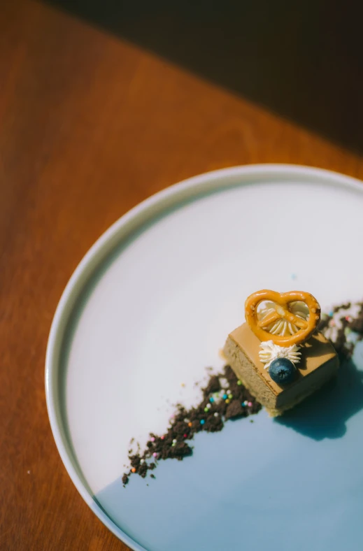 a white plate topped with a piece of cake covered in icing