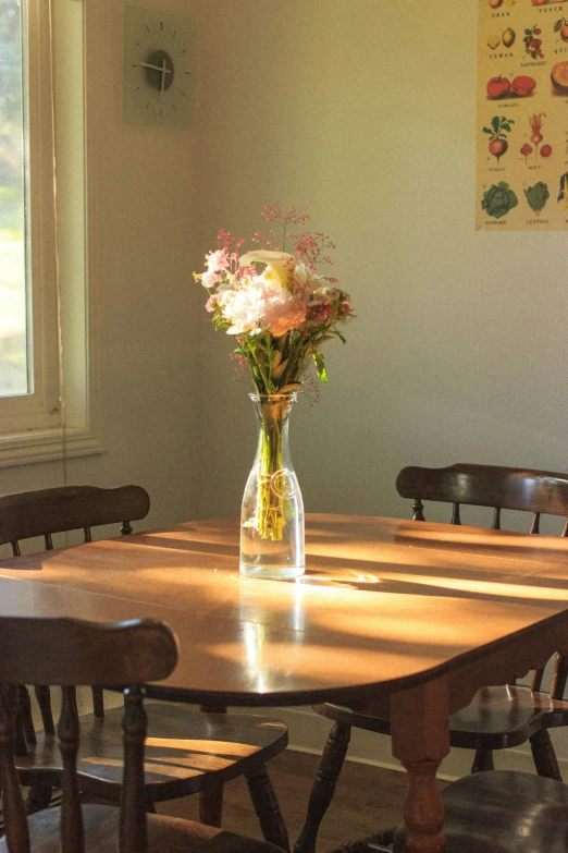 a flower vase sitting on top of a wooden table