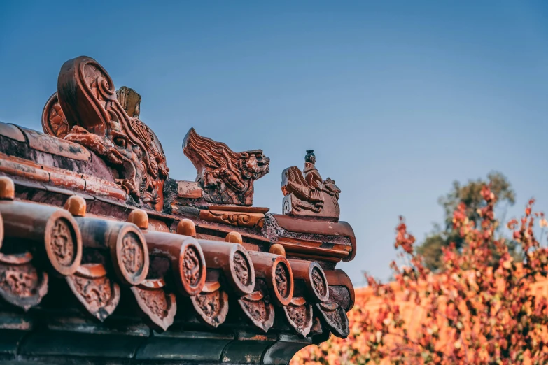 an old model of a building with an owl statue on it's roof