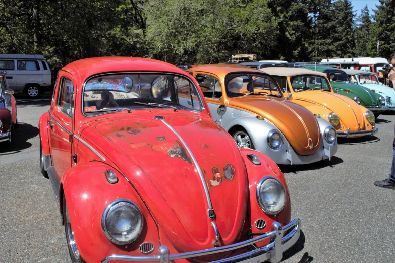 several antique cars parked in a parking lot