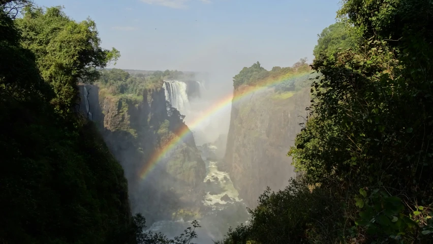 the rainbow appears at the bottom of a waterfall