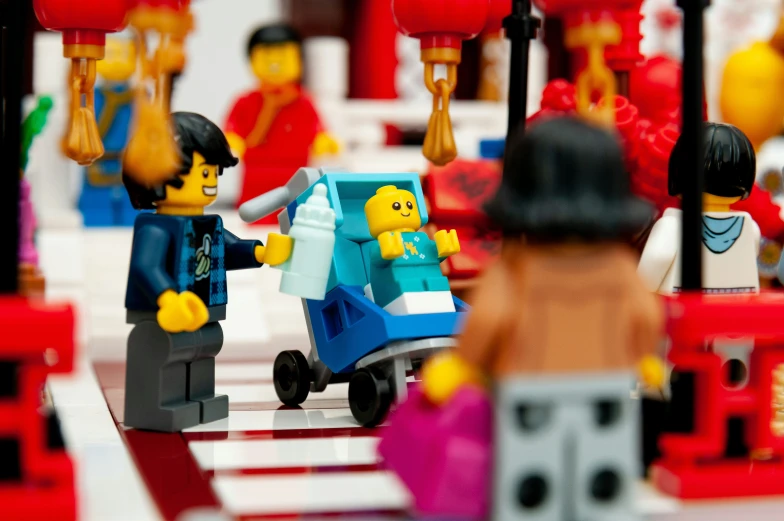a lego city has buildings, cars, and people on it