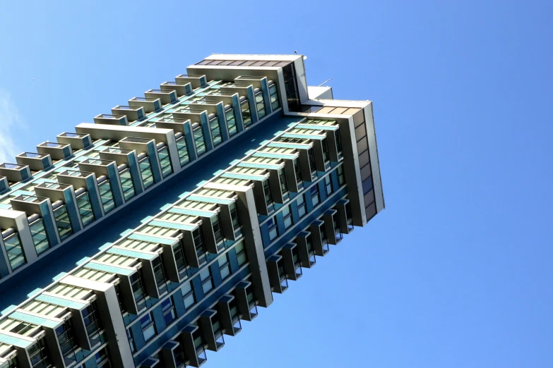 an airplane flying over a tall building on a clear day