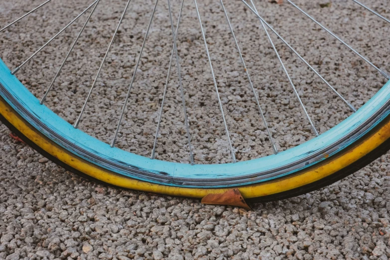 the yellow and blue spokes on a bicycle wheel