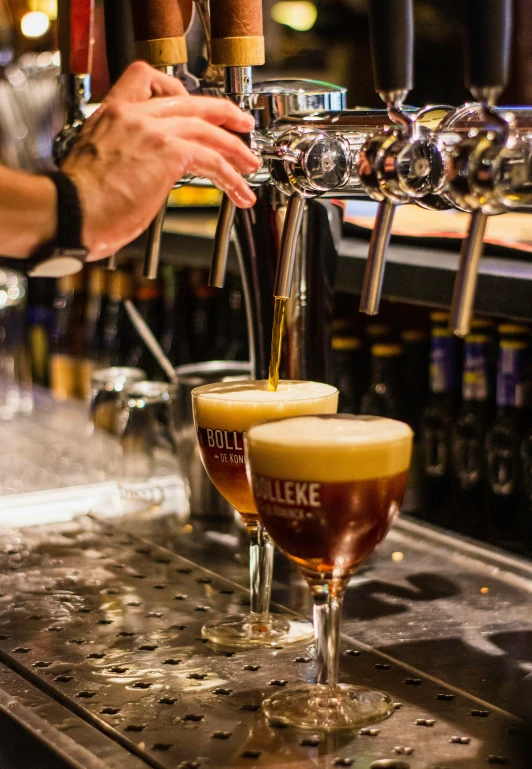 someone filling a mug with a drink from the tap