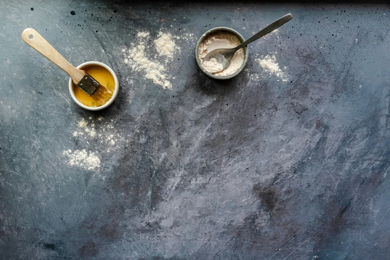 two dishes with sugar and honey sitting on the counter