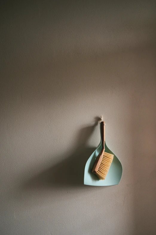 a brush sitting on top of a green bowl