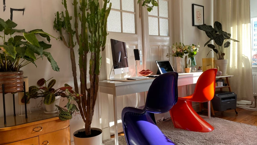 a brightly colored desk sits in the corner of a room