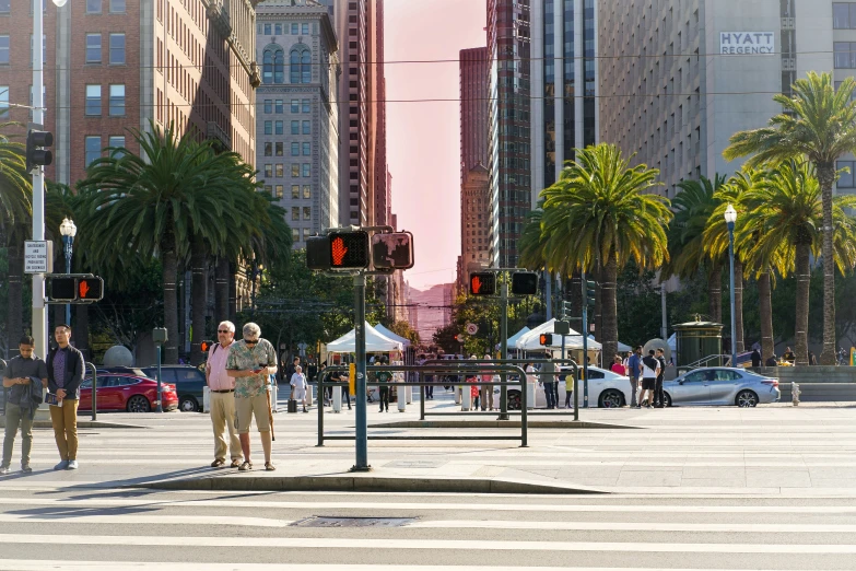 the intersection in a city is crowded with pedestrians