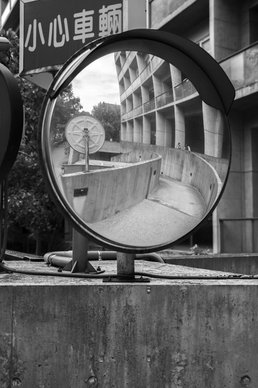 a circular mirror is displayed on a ledge