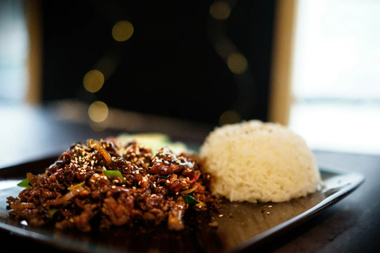 the dish includes rice and meat on the plate